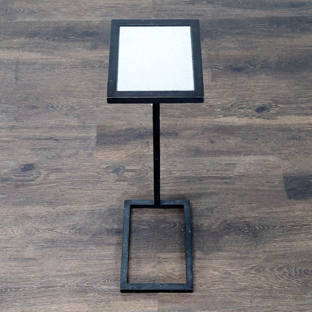 Modern end table by Restoration Hardware; metal base supports a rectangular glass top.