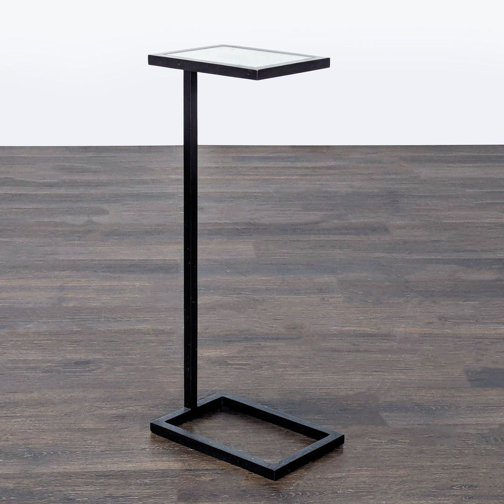 Restoration Hardware C-shaped end table with metal frame and glass top.  