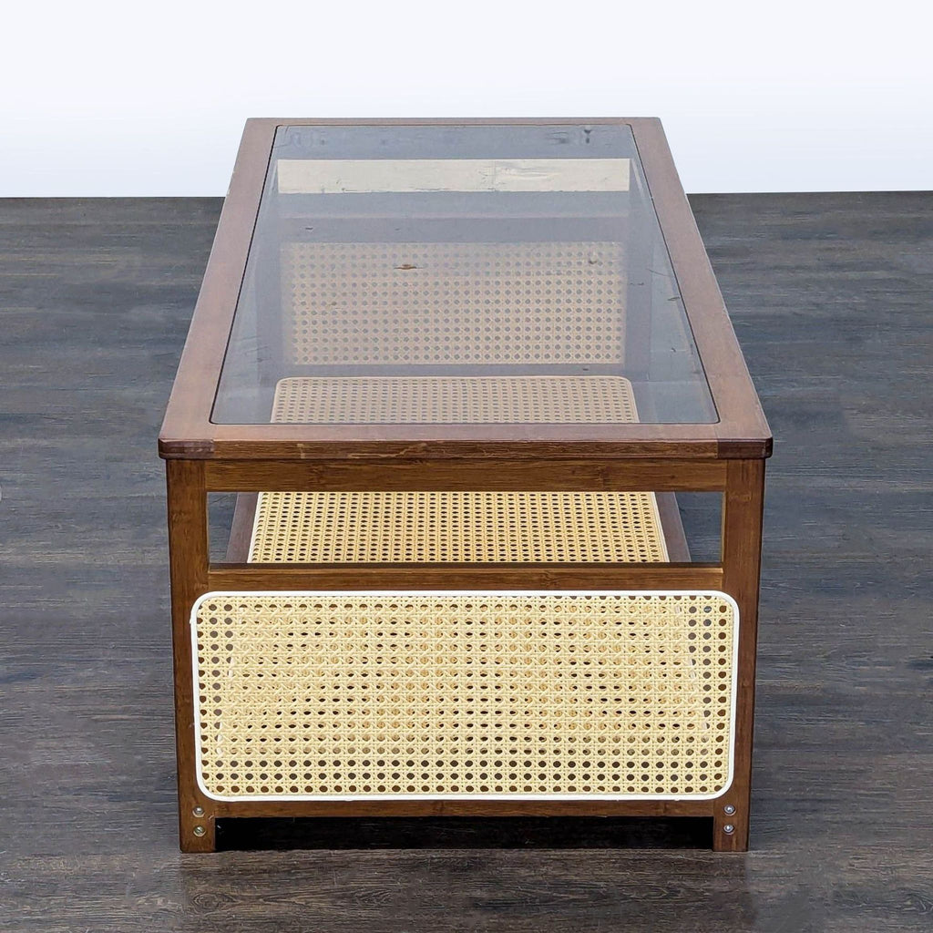 Two-tier walnut coffee table by Welnow, with clear glass top and woven rattan shelf, mid-century inspired.