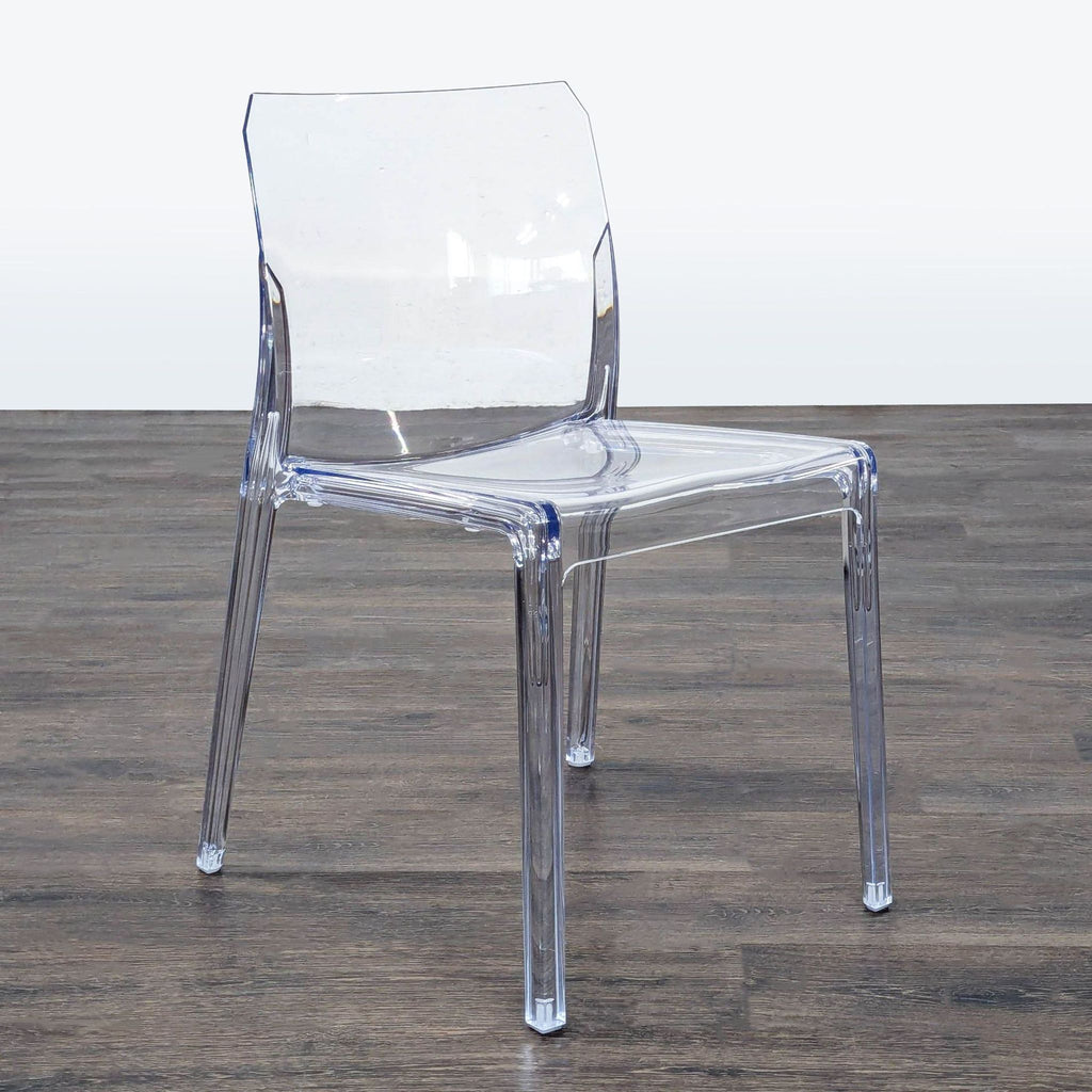 Transparent molded dining chair from CB2, Italian-made with crisp clarity; suitable for outdoor or indoor dining use.