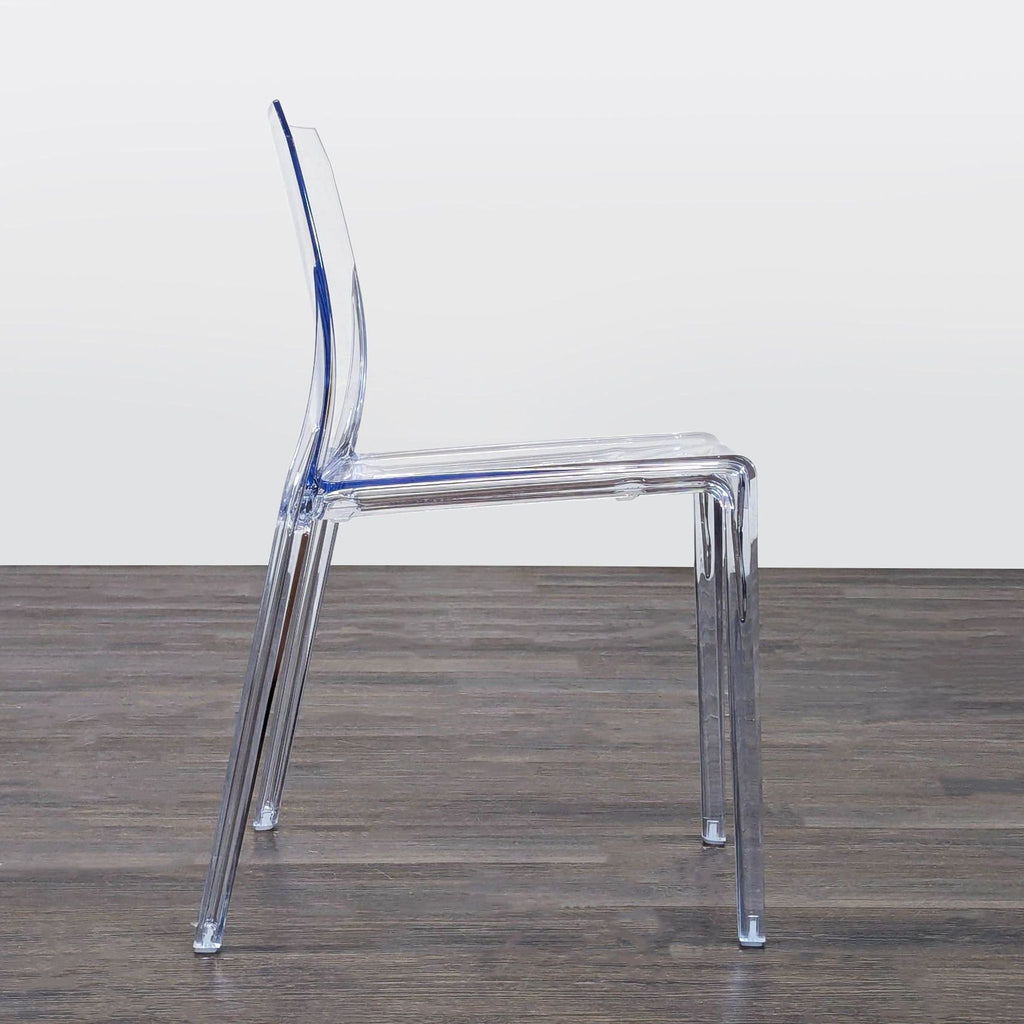 Crystal-clear polycarbonate chair by CB2, crafted below the Alps, combining modern design and glass-inspired style.