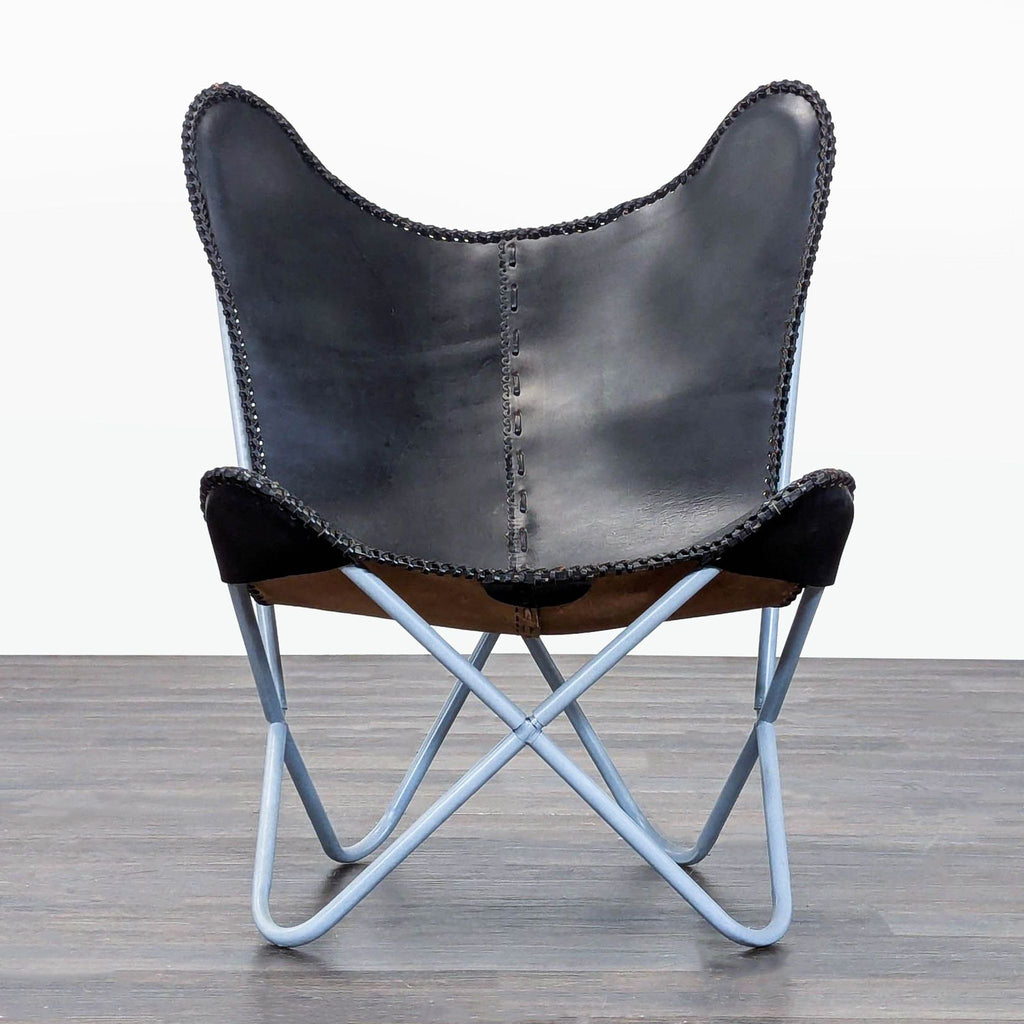 Sleek black and brown leather butterfly lounge chair with stitched details and light blue metal frame.  