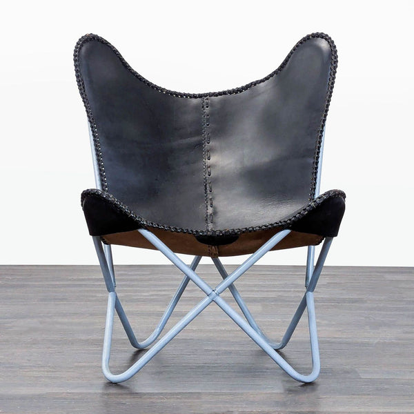 Sleek black and brown leather butterfly lounge chair with stitched details and light blue metal frame.  