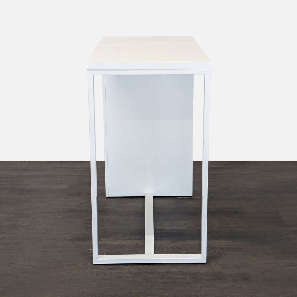 Sleek desk featuring a minimalist design and three open shelves, suitable for home office setups.