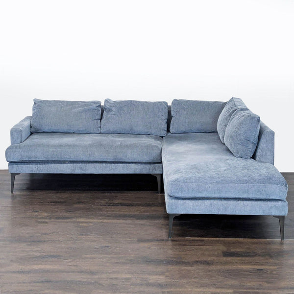 Modern gray West Elm sectional sofa with deep lounge chaise and plush cushions, ideal for a family room.  