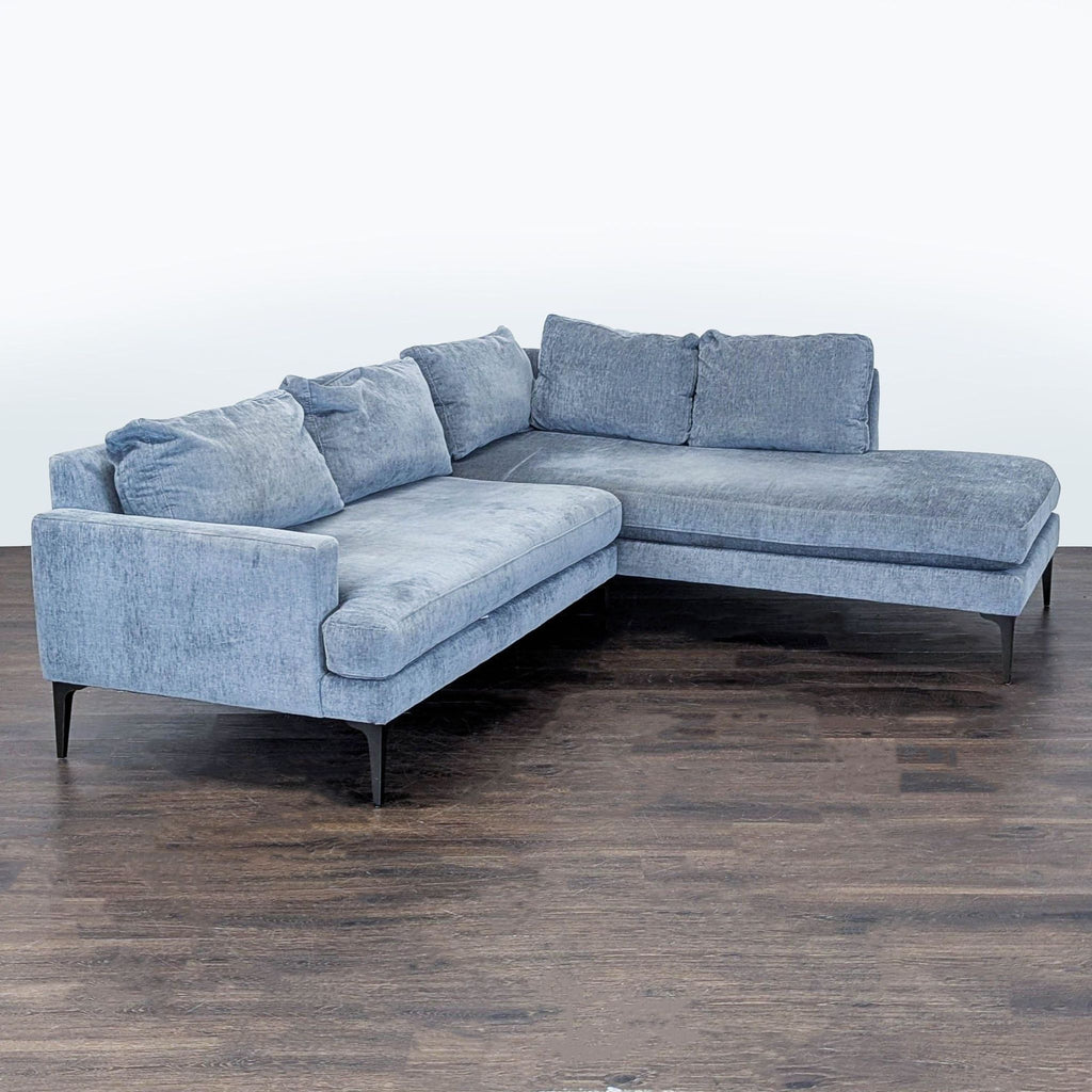 Spacious West Elm sectional in neutral gray fabric, featuring clean lines and sturdy build for daily use.  