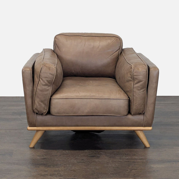 Brown leather Article lounge chair with wooden base, wide seat, and plush cushions in great used condition.  