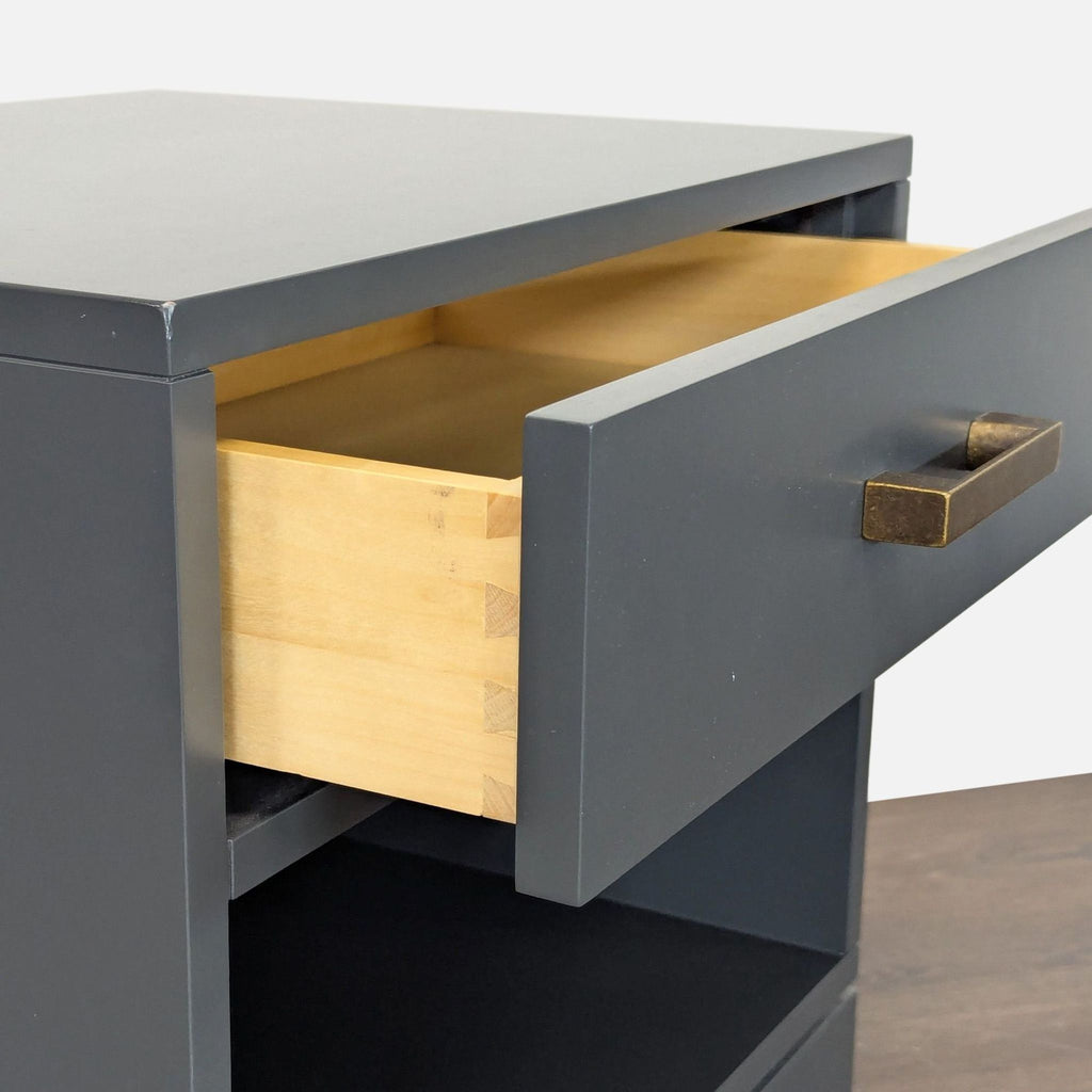 3. Compact end table by The Land of Nod with single drawer and an open bottom shelf.
