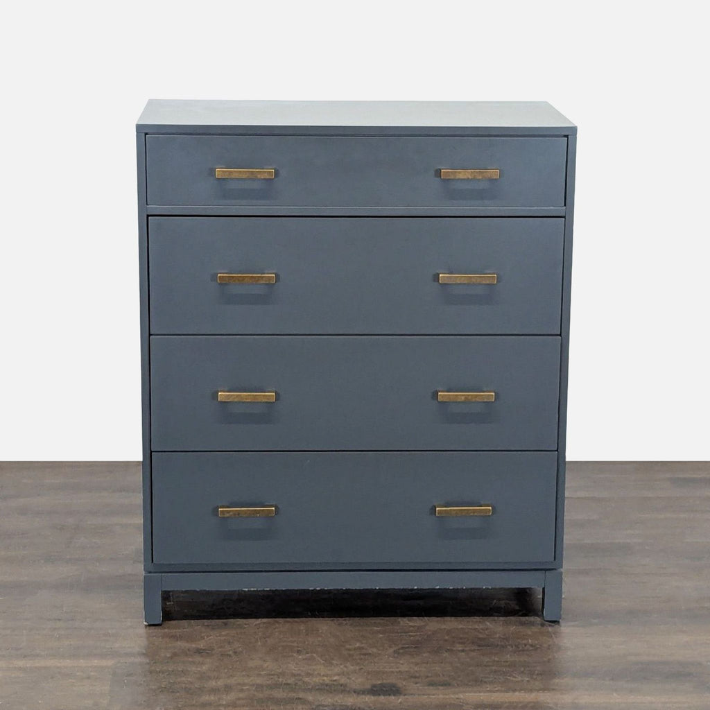 Sleek The Land of Nod dresser with four roomy drawers and brass handles, ideal for modern bedrooms.