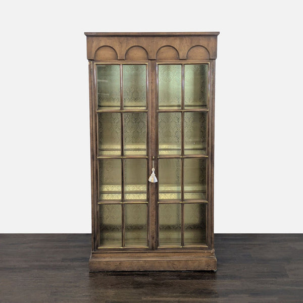Glass-doored cabinet with grid design, three shelves, and a patterned-backed, illuminated interior.