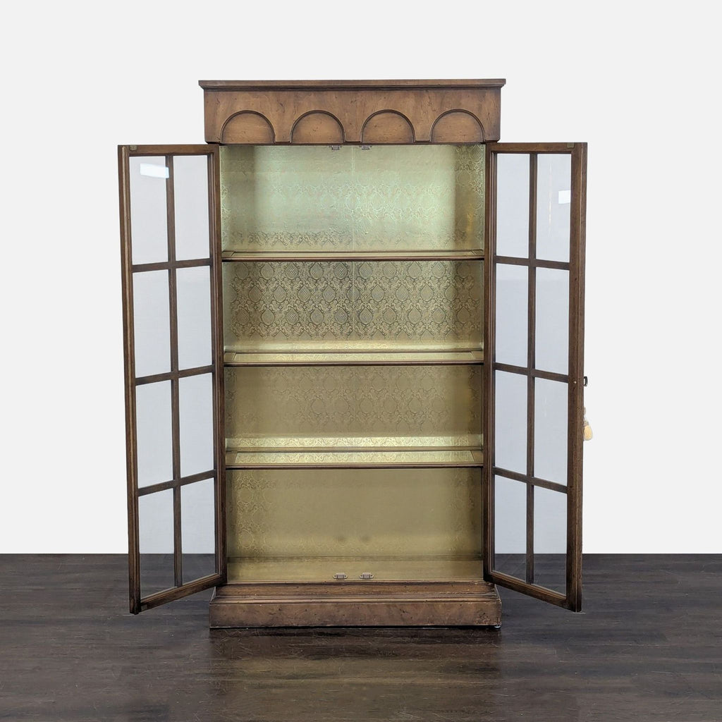 Classic cabinet with two glass doors and visible shelves, featuring decorative backing and built-in lighting.