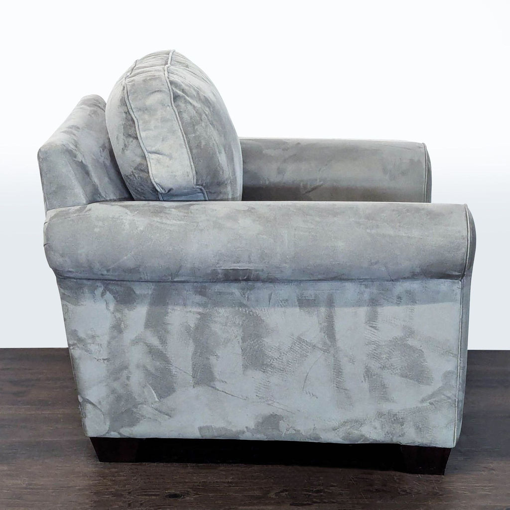 3. Side profile of a gray Pottery Barn lounge chair, highlighting its thick cushions and classic lounge design.