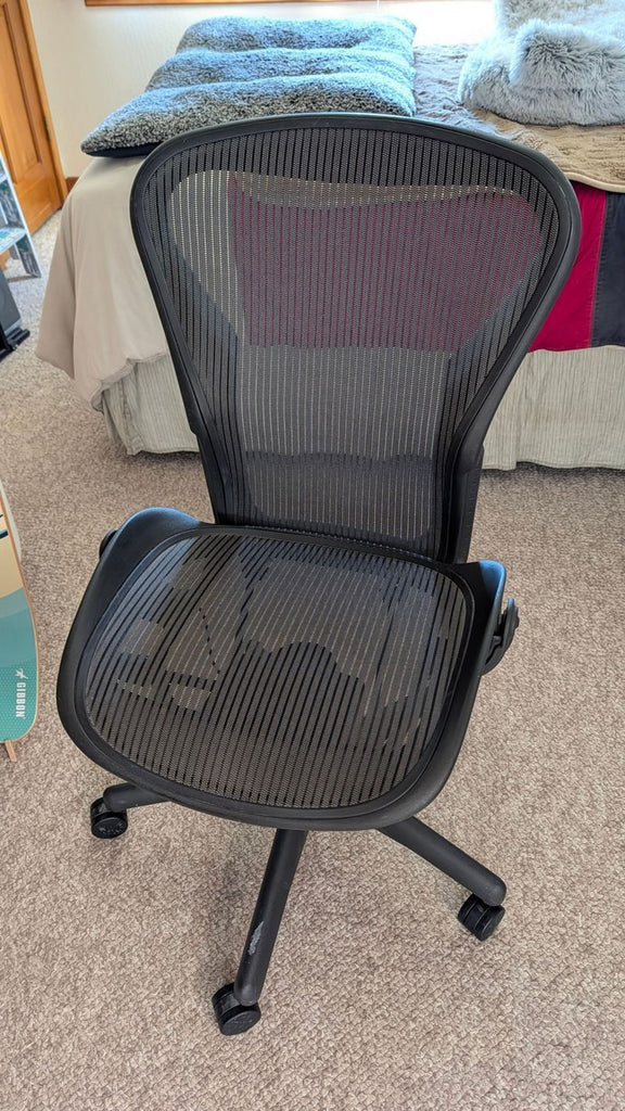 Pair of Herman Miller Aeron office chairs in black, both in good working condition.  