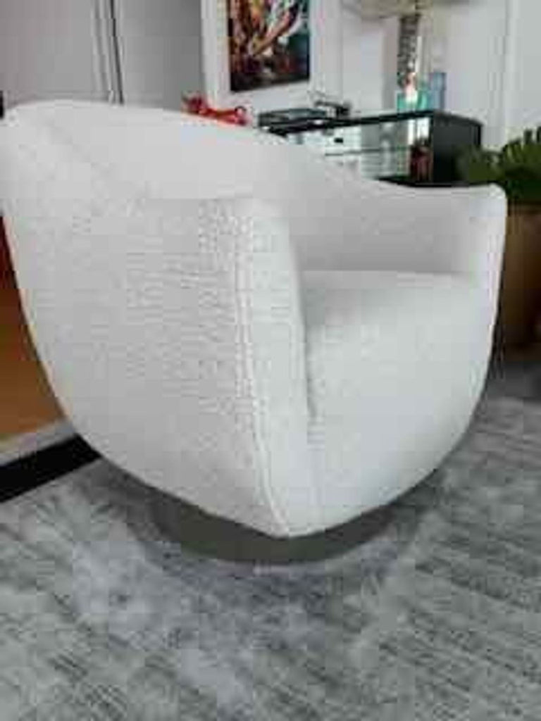 1. Modern white boucle lounge chair by Interlude Home, featuring a rounded back and swivel base in a living room setting.