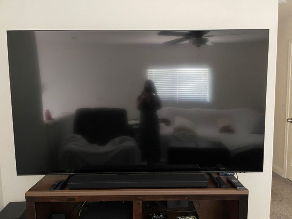 a person is standing in front of a tv.