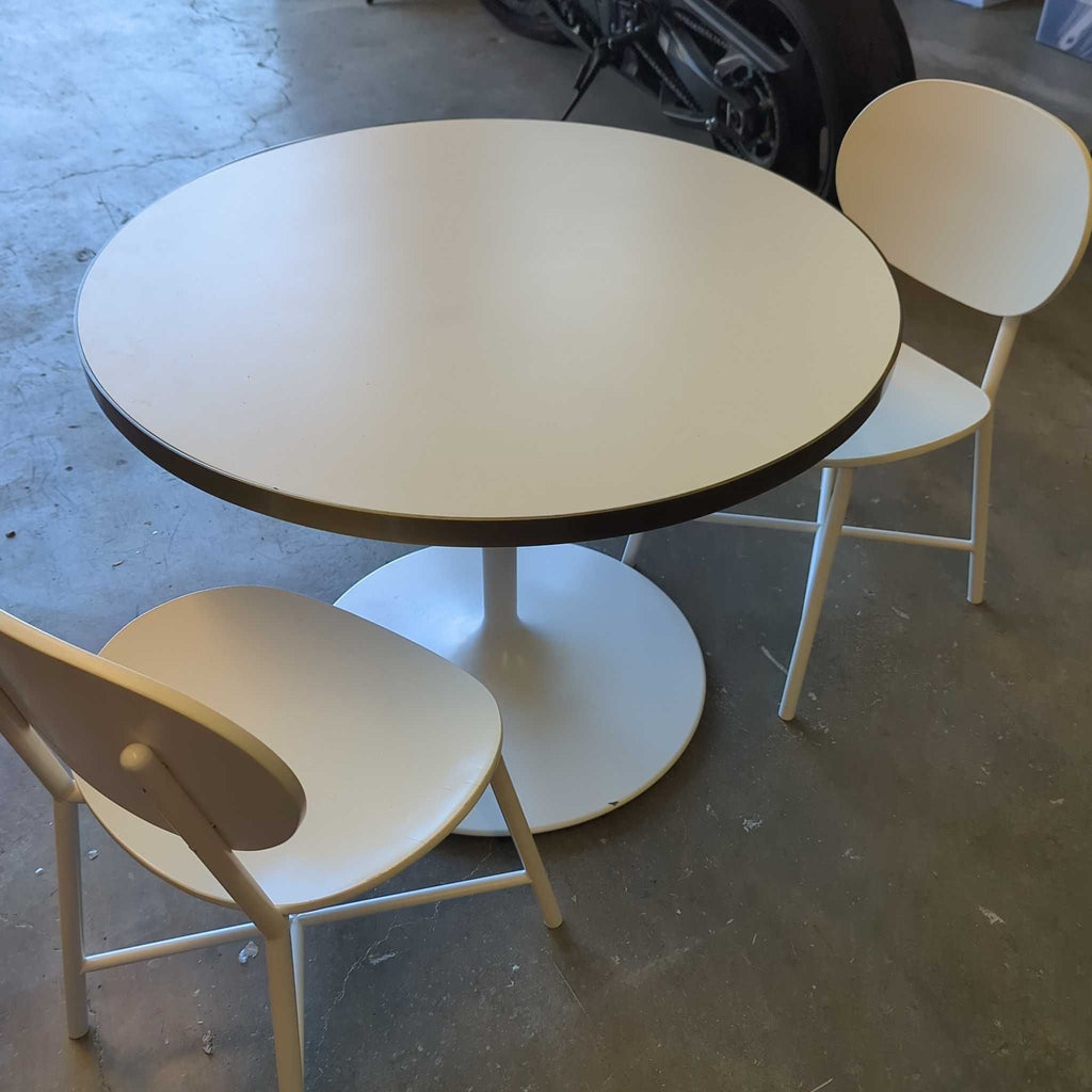 1. Modern dining set with a rectangular wooden table and four matching chairs in a bright room.  