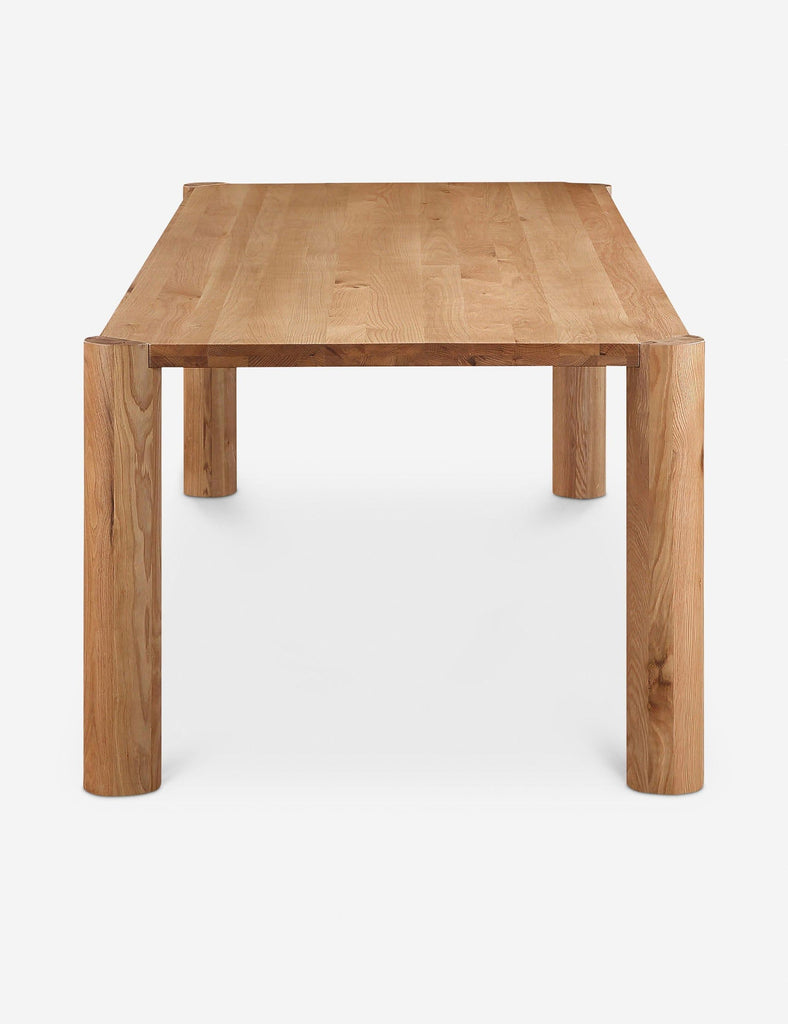 3. End view of Lulu and Georgia dining table, highlighting its smooth wooden surface and round corner legs.