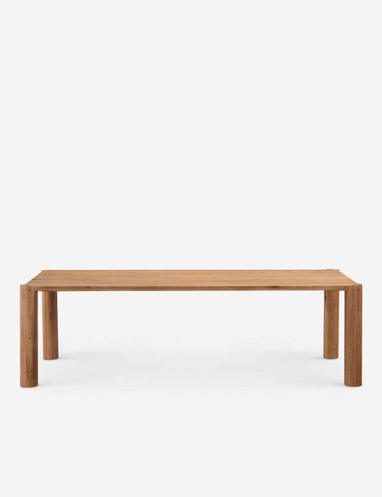 2. Front view of minimalist Lulu and Georgia dining table, featuring solid wood build and cylindrical legs.