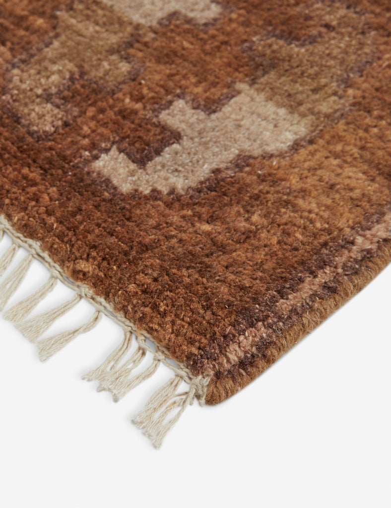 a handmade wool rug with a geometric design.