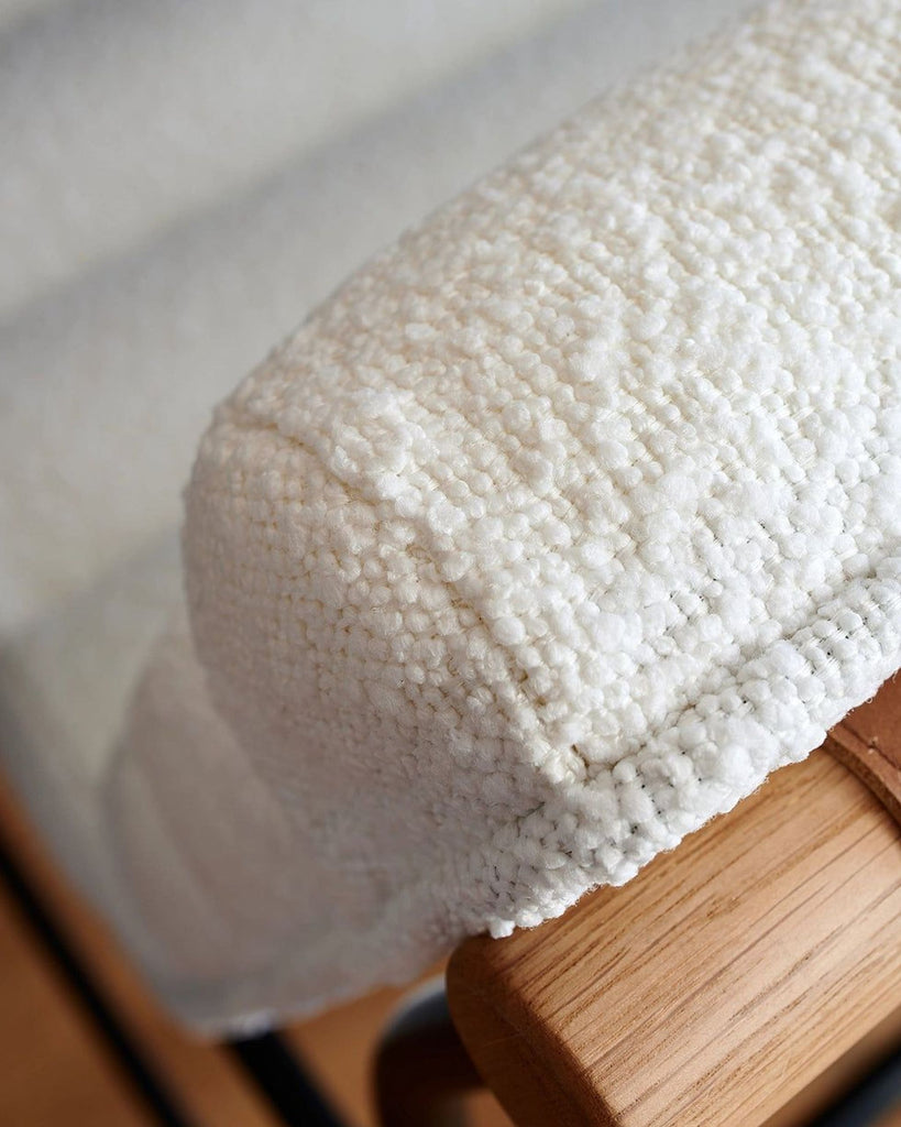 a close up of a white towel on a wooden table.