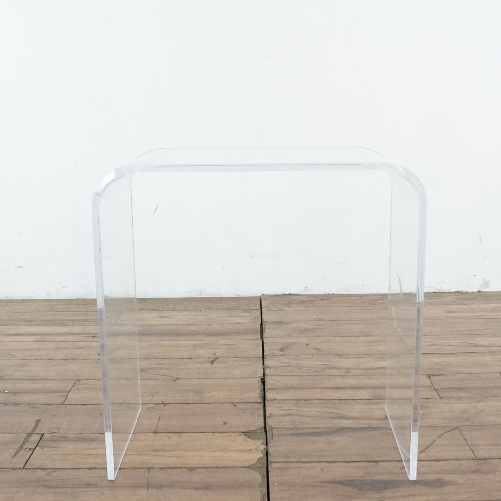 3. Front-facing Reperch end table featuring waterfall style, made of transparent material on wood flooring.