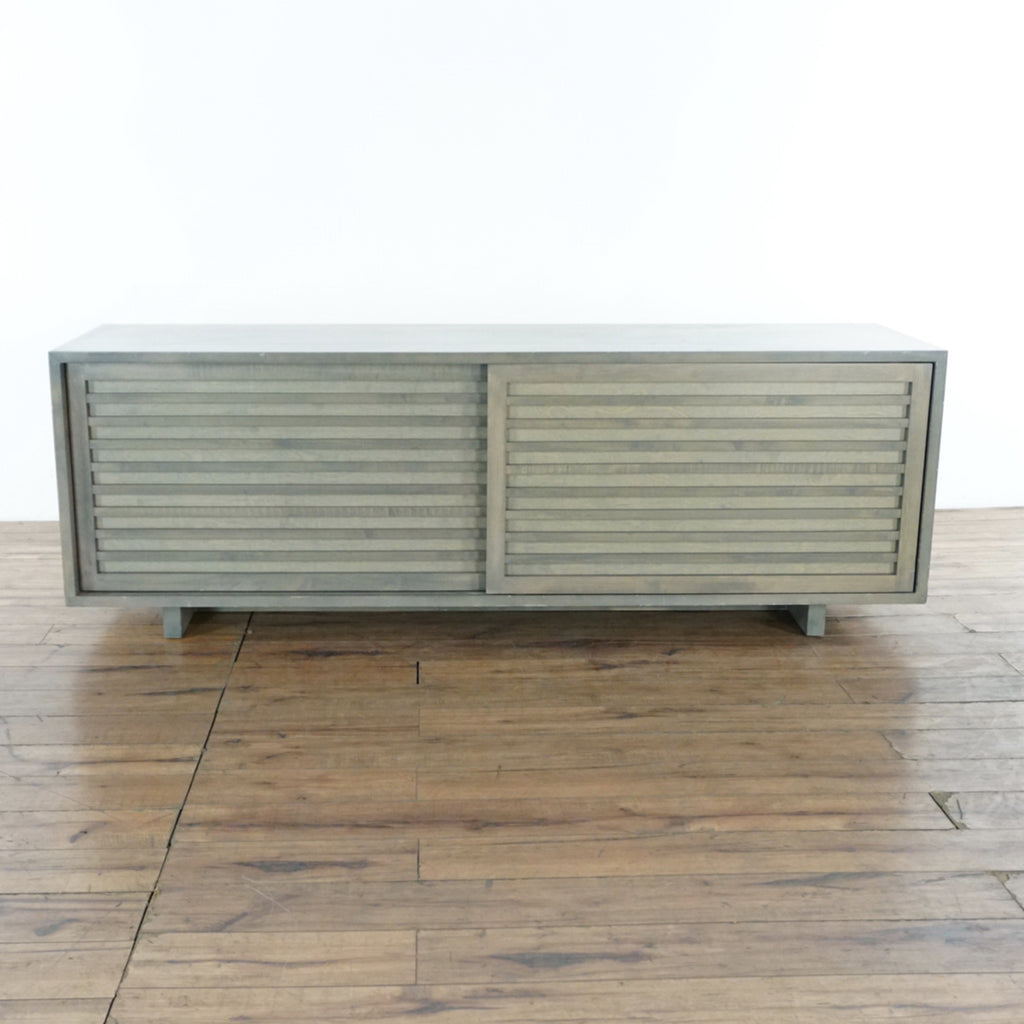 1. Reperch entertainment center with sliding louvre doors in a bleached gray finish, viewed from the front.