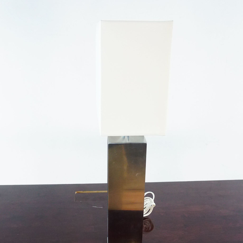 3. Side view of an Ikea lamp featuring an aluminum-colored base and white shade, designed for modern lighting.
