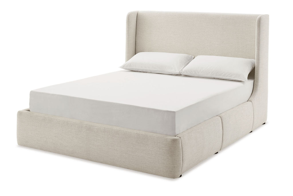 2. Angled side view of a Reperch frame bed in light upholstery, showing its soft, fully covered structure.  