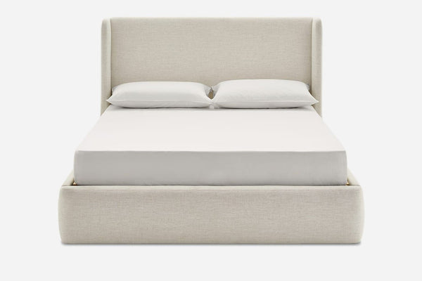 1. Front view of a Reperch frame bed in light fabric with a tall headboard, mattress, and pillows.  