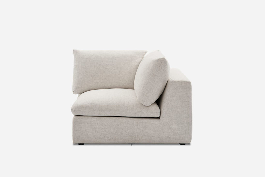 3. Modern beige Castlery sectional corner piece, featuring wide seat, square armrest, and soft pillows.