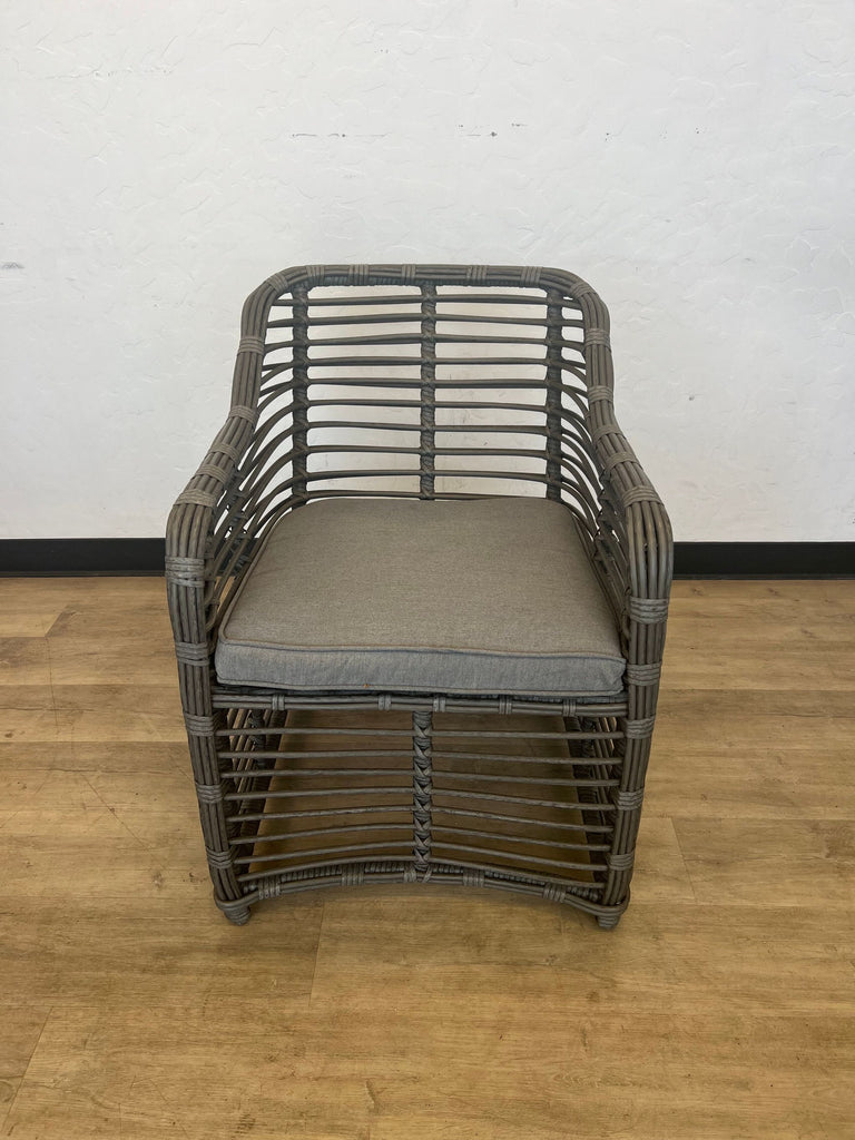 Woven bamboo lounge chair with square back and a grey cushion.