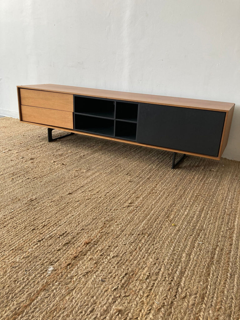 DWR Aura Media Unit showcasing minimalist design with ample storage and natural wood tones.