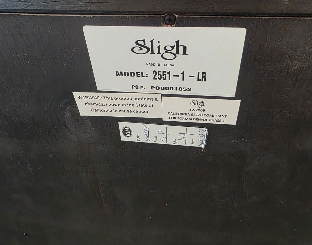 Elegant Sligh-brand cabinet with carved details and spacious drawers, ideal for organized storage.