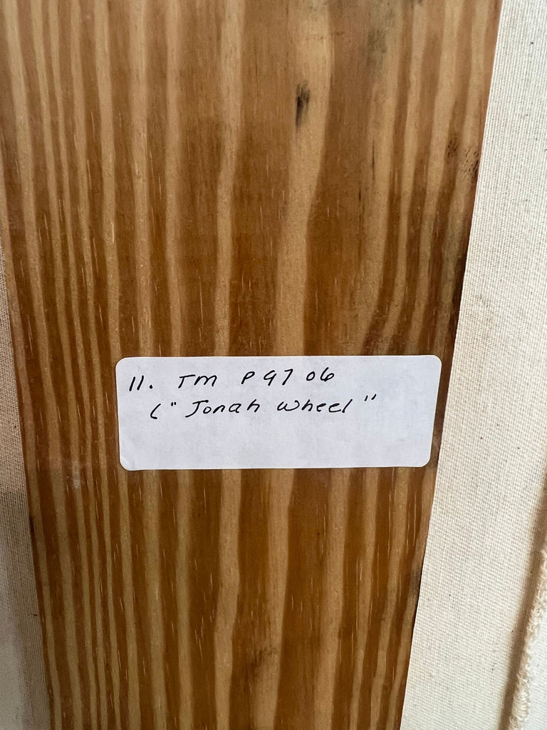 Wood panel with handwritten label indicating "Jonah Wheel" artwork by Todd Murphy.