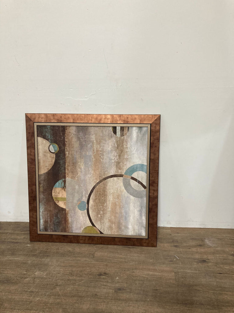 1. Framed abstract Reperch painting featuring overlapping circles and muted earth tones, leaning against a wall.