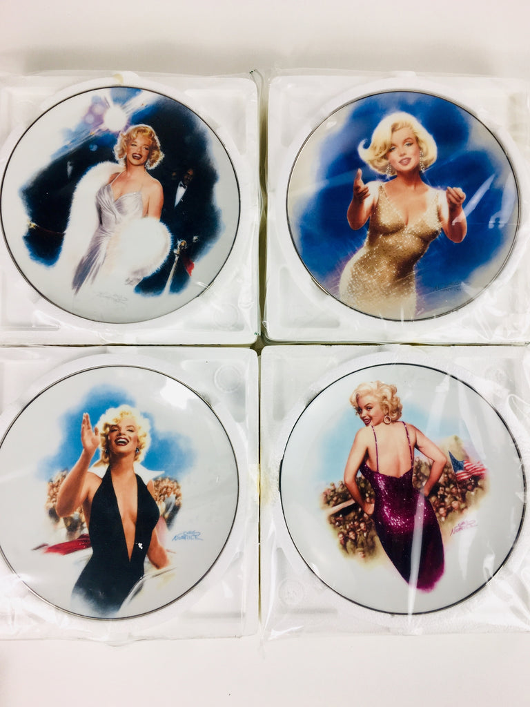 2. Four Bradford Exchange dishware plates, each showcasing a different vintage Hollywood star illustration, new in packaging.