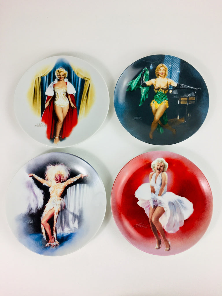 1. Set of four Bradford Exchange collector plates featuring glamorous movie scenes, each with unique illustrated portraits.