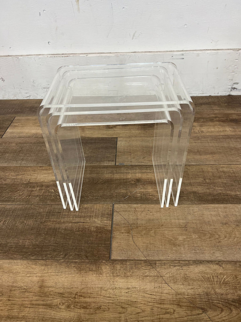 Set of three transparent end tables stacked on each other.