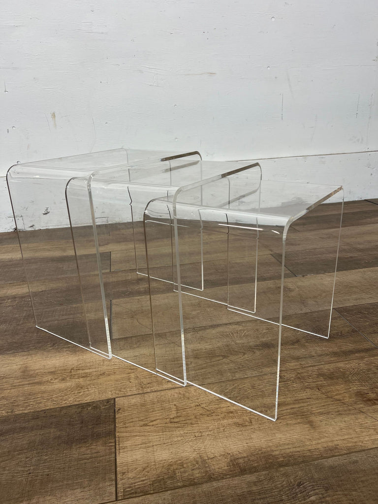 Minimalist acrylic end tables showcasing a modern design.