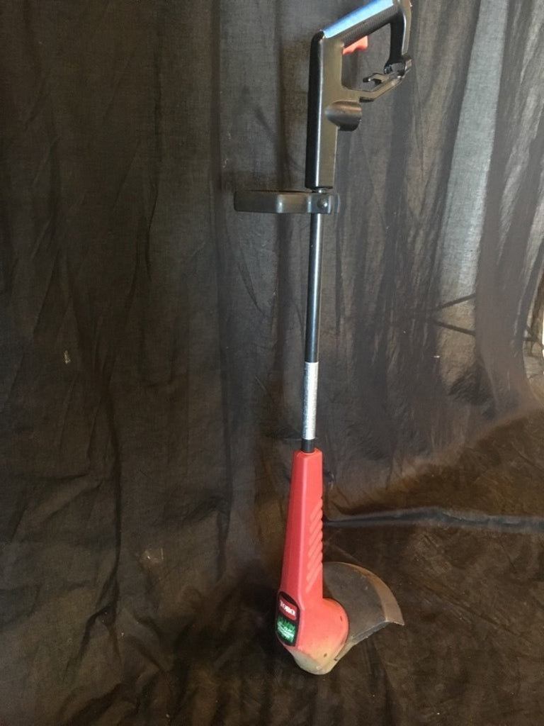 3. Side view of Toro 11" wire electric trimmer/edger, showing handle and protective guard, categorized as a tool.