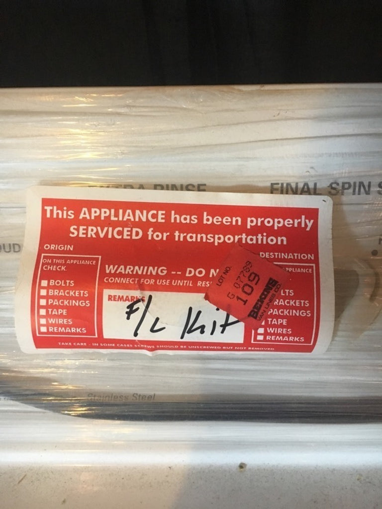 3. Red service sticker on Kenmore washer indicating it’s been properly checked and prepared for transport.
