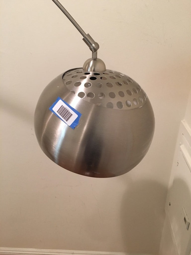 3. Detailed view of the Reperch floor lamp’s chrome dome-shaped shade with ventilation holes and barcode sticker.