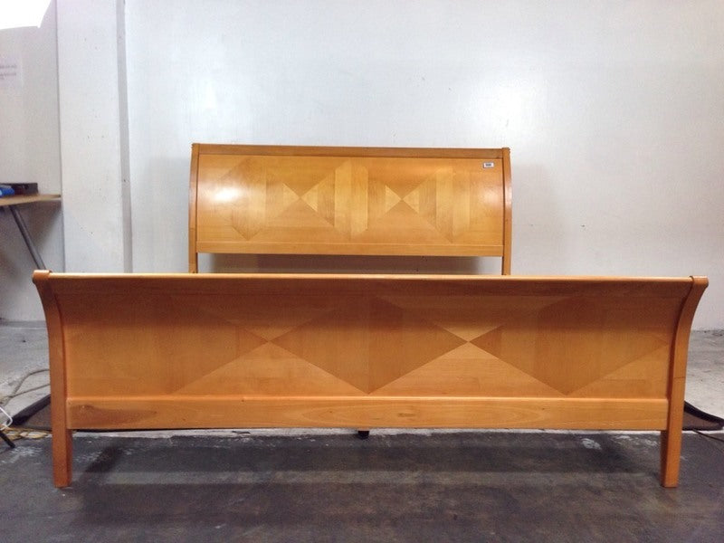 2. Wooden Reperch bed set with detailed diamond designs across the headboard and footboard.