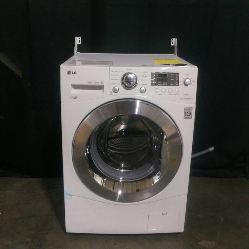 LG WM1377HW front load washer with chrome door, digital controls, and detergent drawer, shown from the front.  