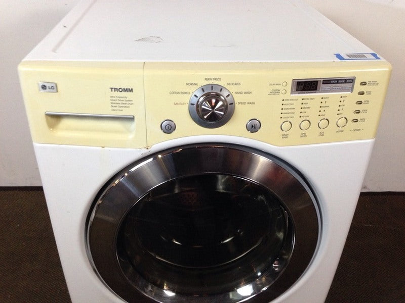 2. Close-up of the LG brand washing machine’s control panel, buttons, and circular door.