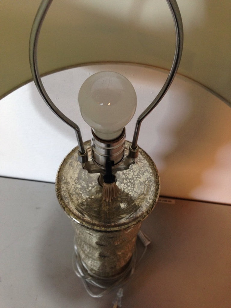 Close-up top view of the Visual Comfort Lamp by Reperch, highlighting its silver base and light bulb socket.