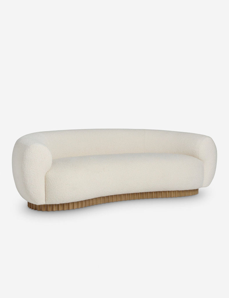 2. Angled side view of a Reperch 3-seat sofa, featuring smooth cream fabric and rounded arms.  