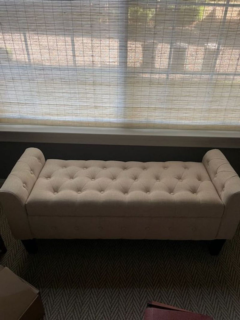 a couch with a window and a window blind 