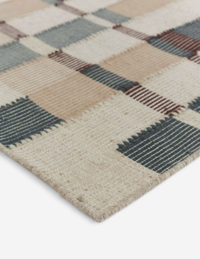 a close up of a woolly rug with a brown and beige checkered design.