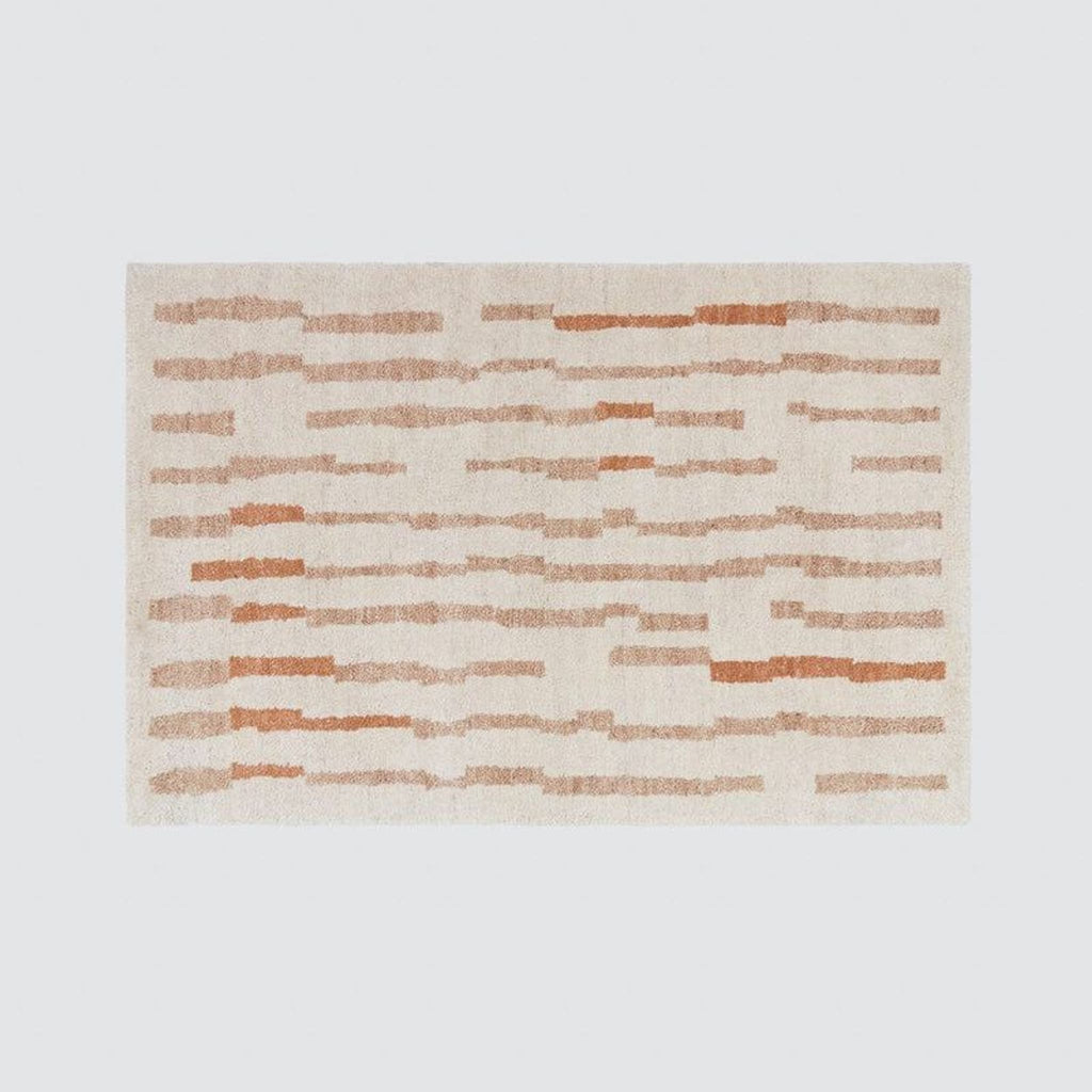 1. Rectangular rug with irregular horizontal tan and rust stripes, hand-knotted from New Zealand wool by The Citizenry.